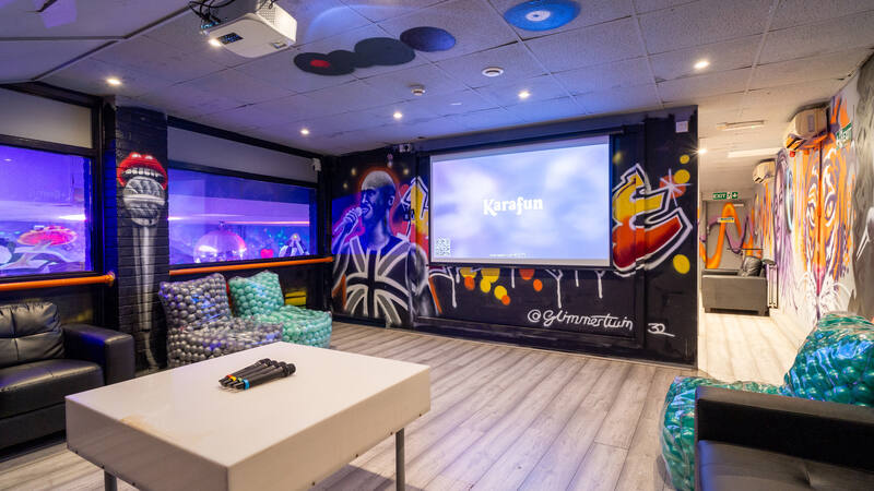 The karaoke room, with its screen and sofas